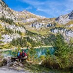 A couple admires lake and mountain views in the Swiss Oberland.
