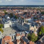 From above of historical Bruges City Hall located on Burg Square near canal and aged buildings on sunny day